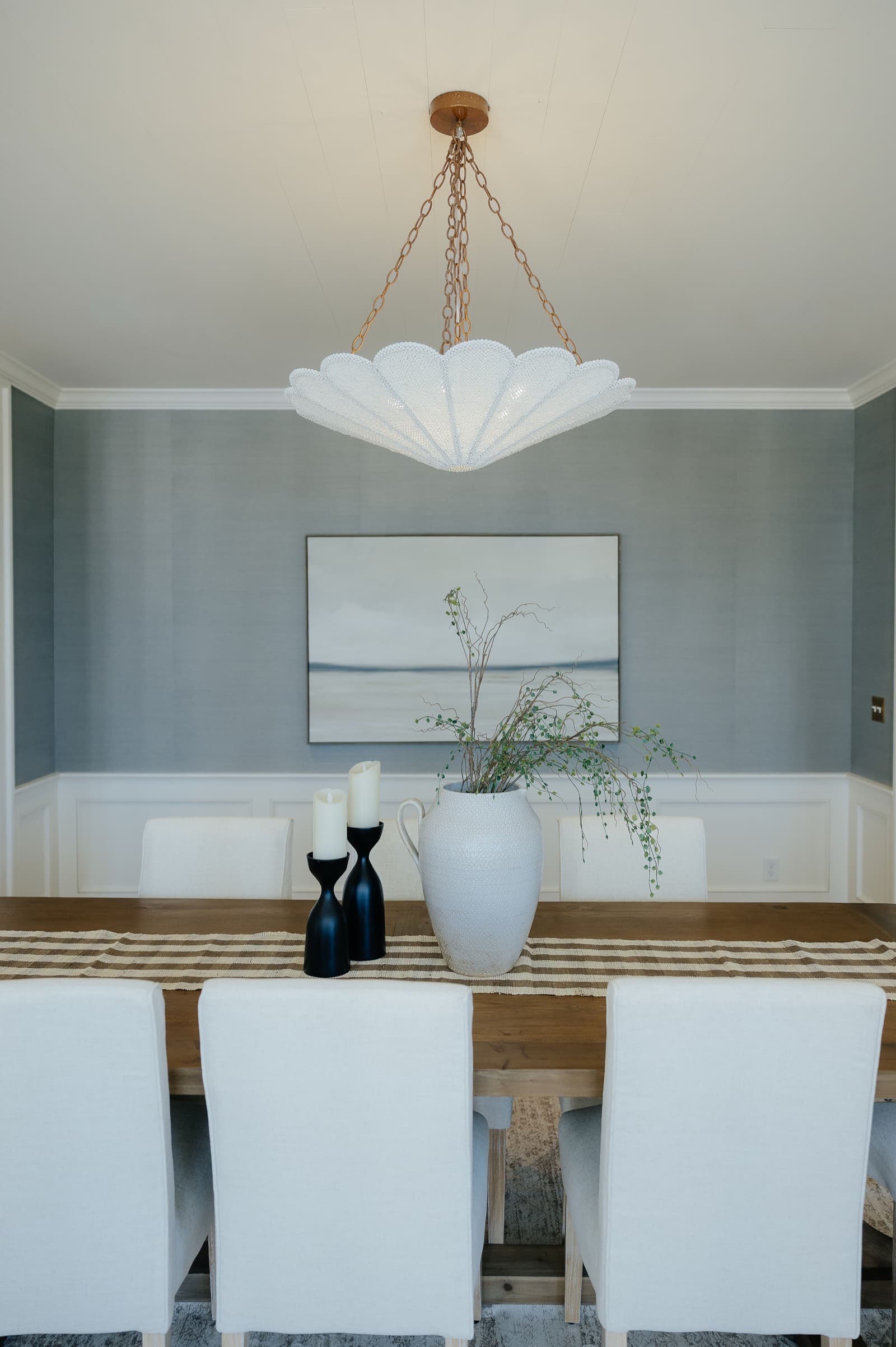 Elegant Utah dining room with blue accent wall and modern chandelier