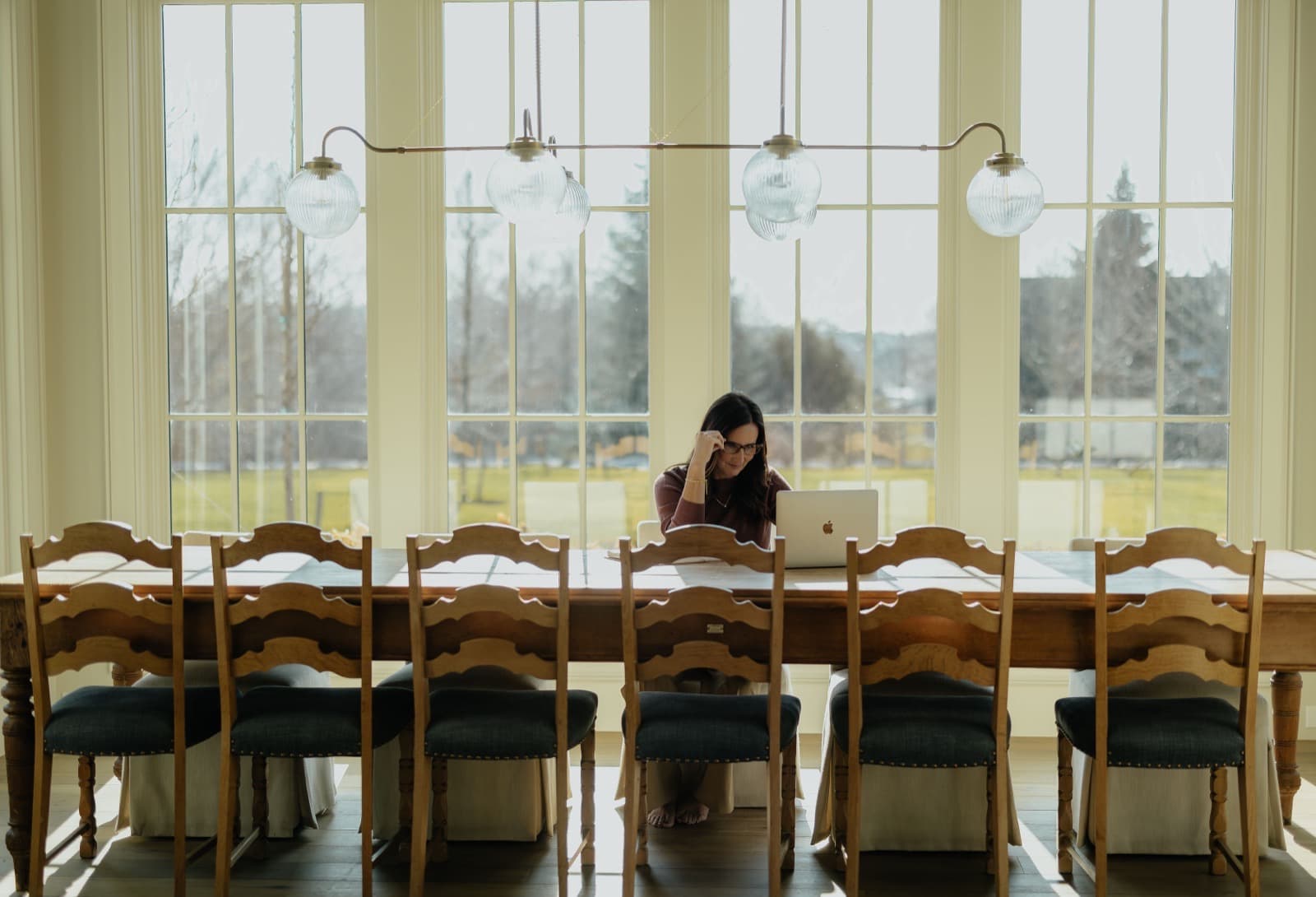 Nicki working at a dining table in an Alpine Utah home